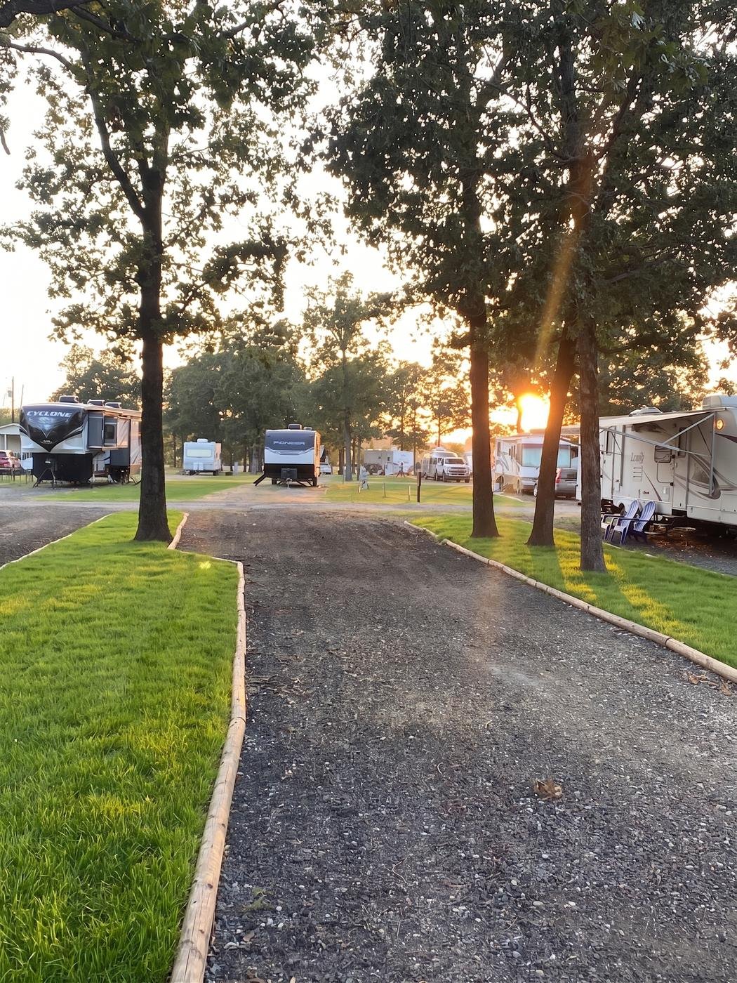 Golden-hour view along the gravel loop between RV site rows