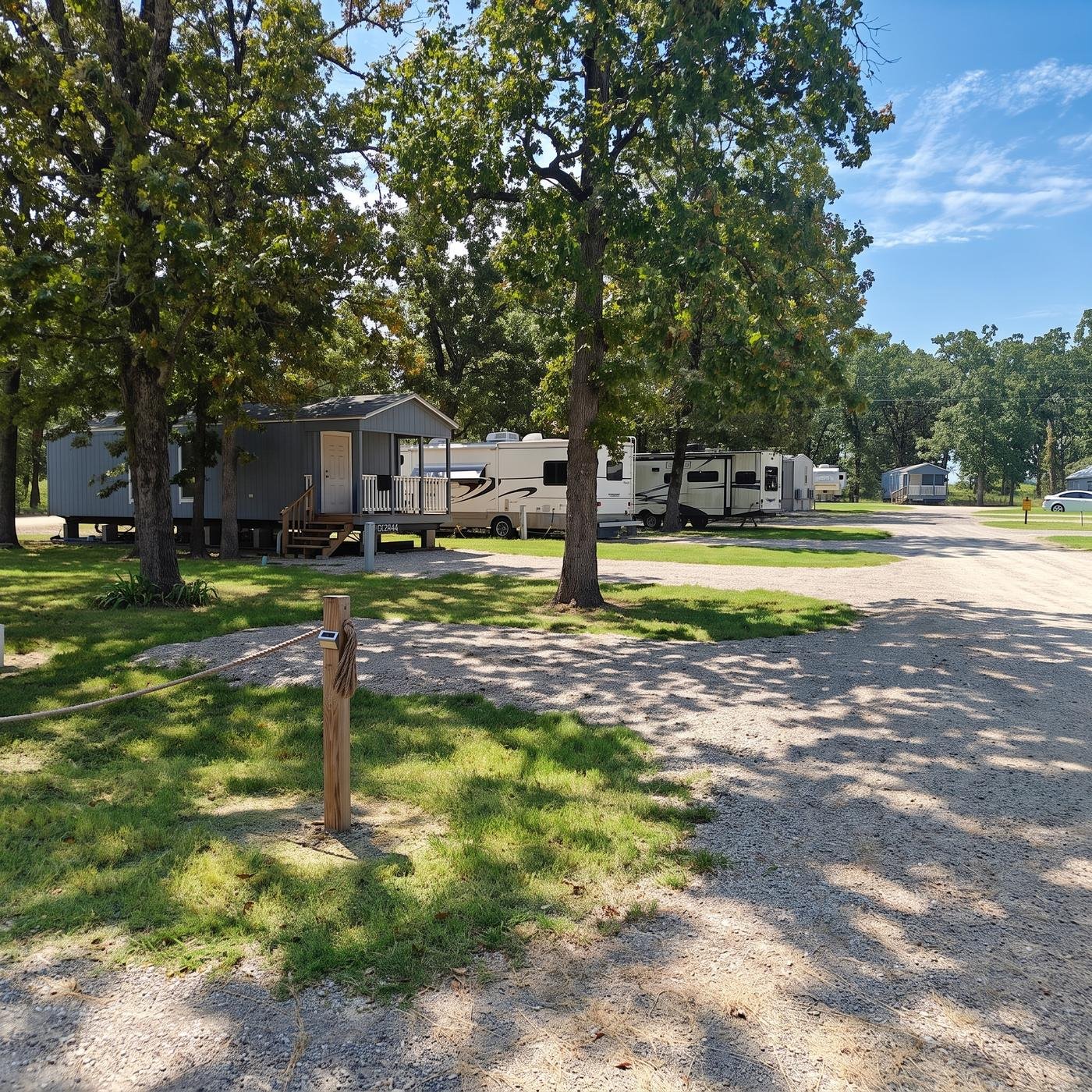 Tiny home with a covered porch and paved parking pad