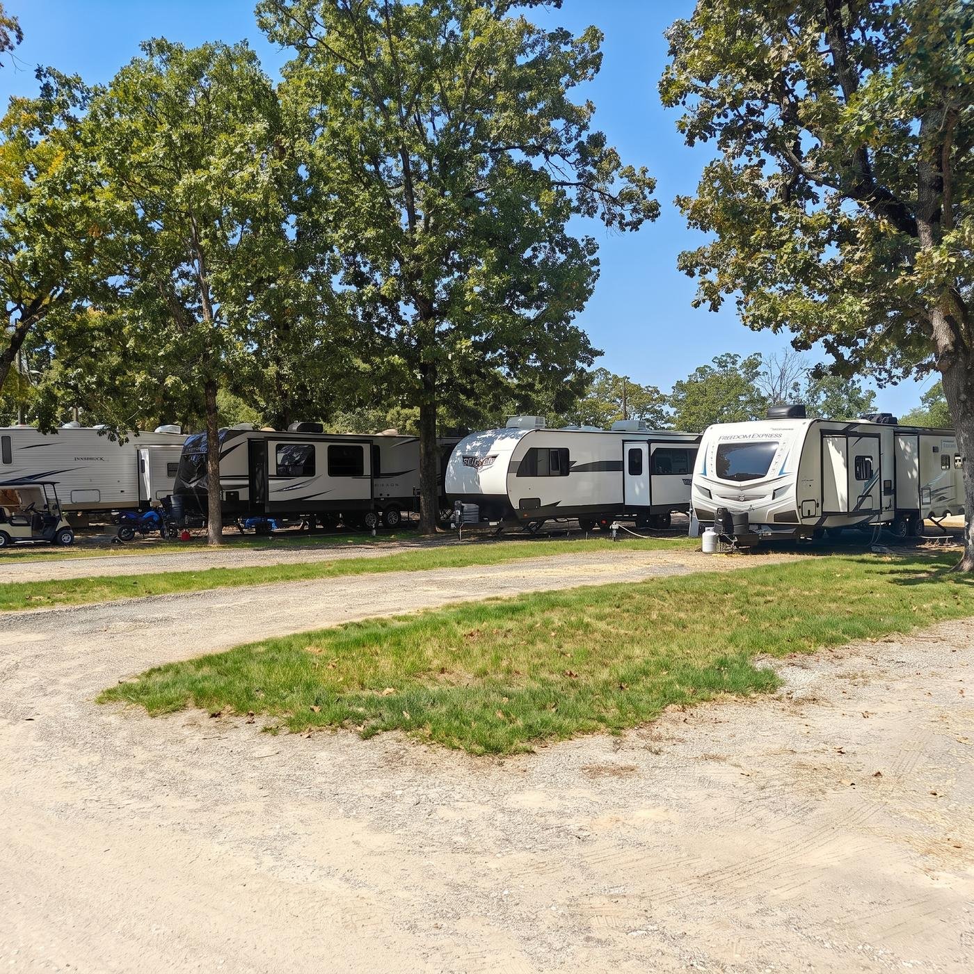 Row of RVs parked along the gravel drive