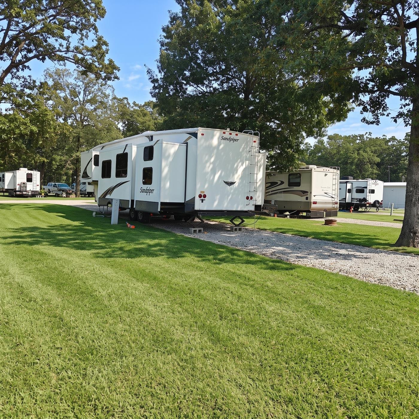 Fifth wheel trailer parked among the trees