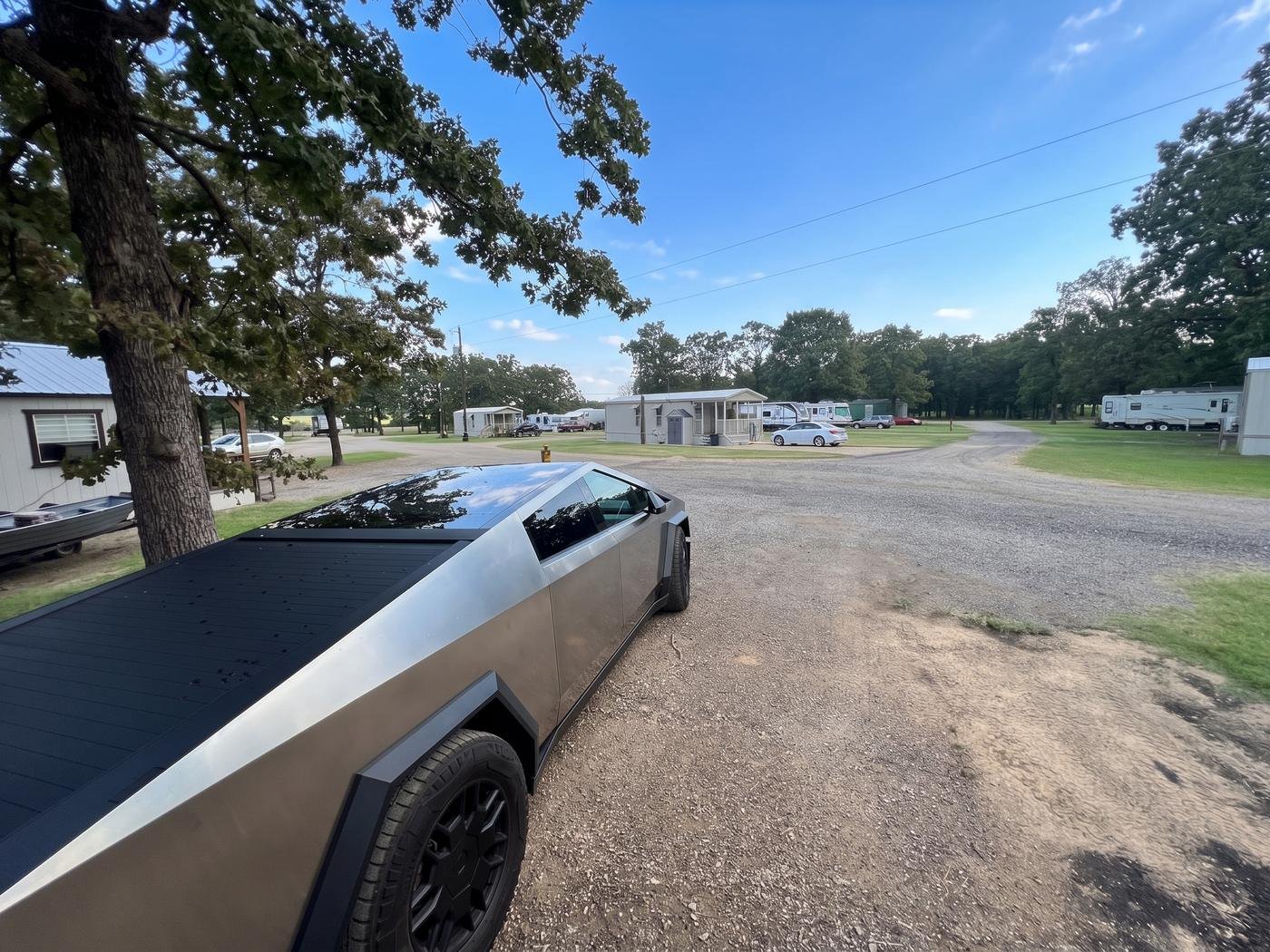 View of the gravel drive leading into the park, past the office and RV rows