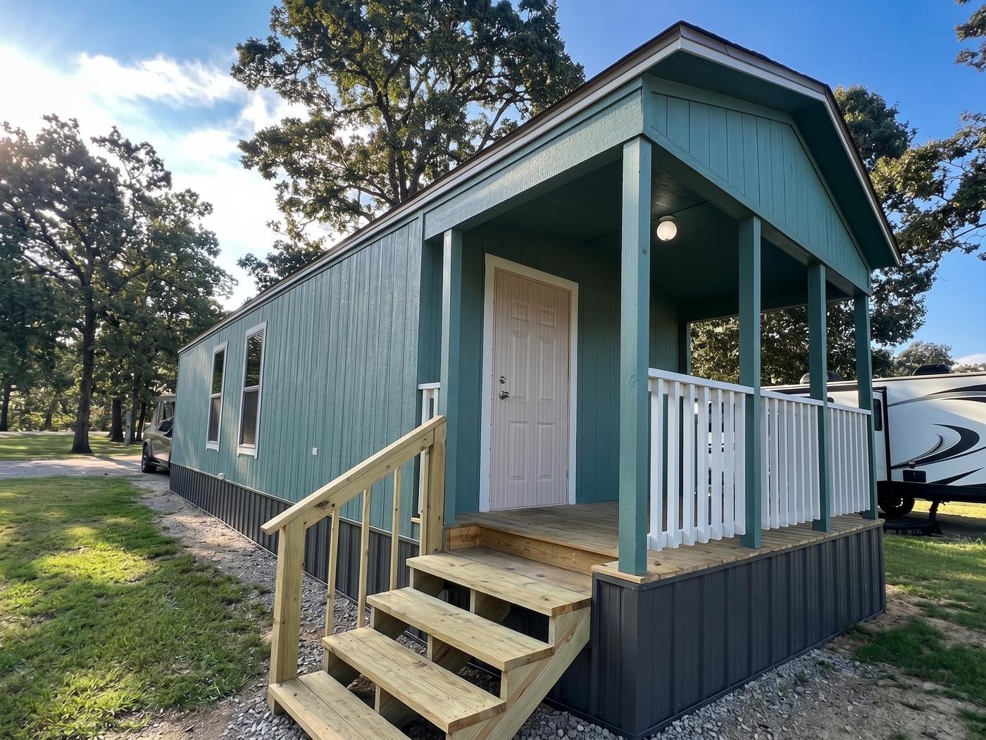 Tiny home with a covered front porch and wooden steps